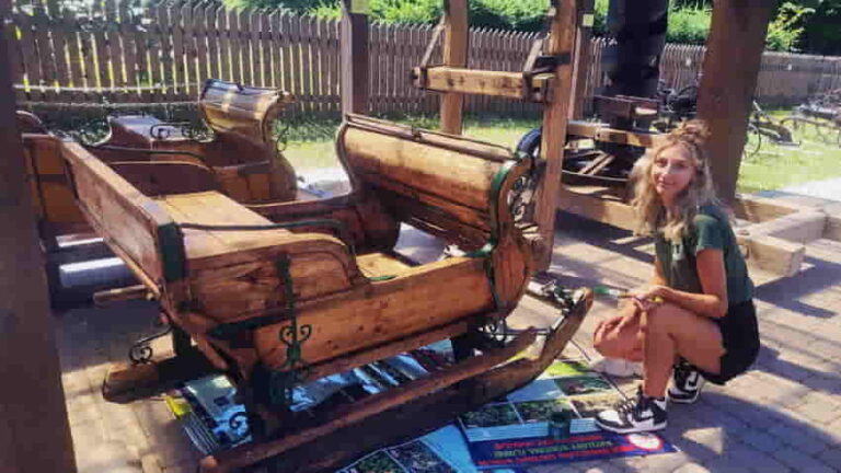 Kobieta odnawia drewniane sanie.